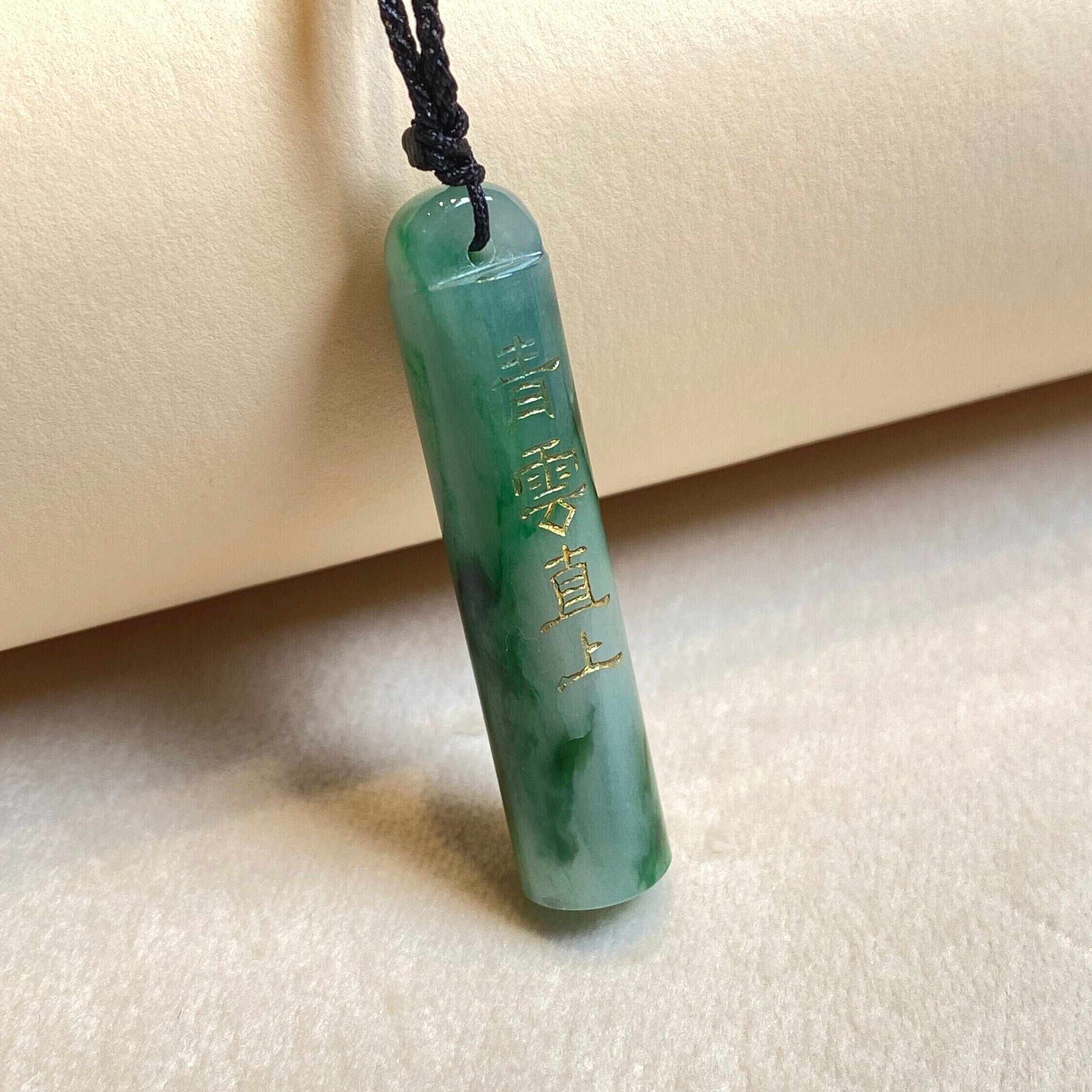 An Exceptional Carved Jadeite Lingguan Tube Pendant Necklace