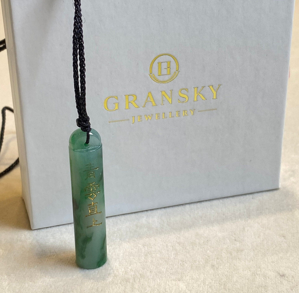 An Exceptional Carved Jadeite Lingguan Tube Pendant Necklace