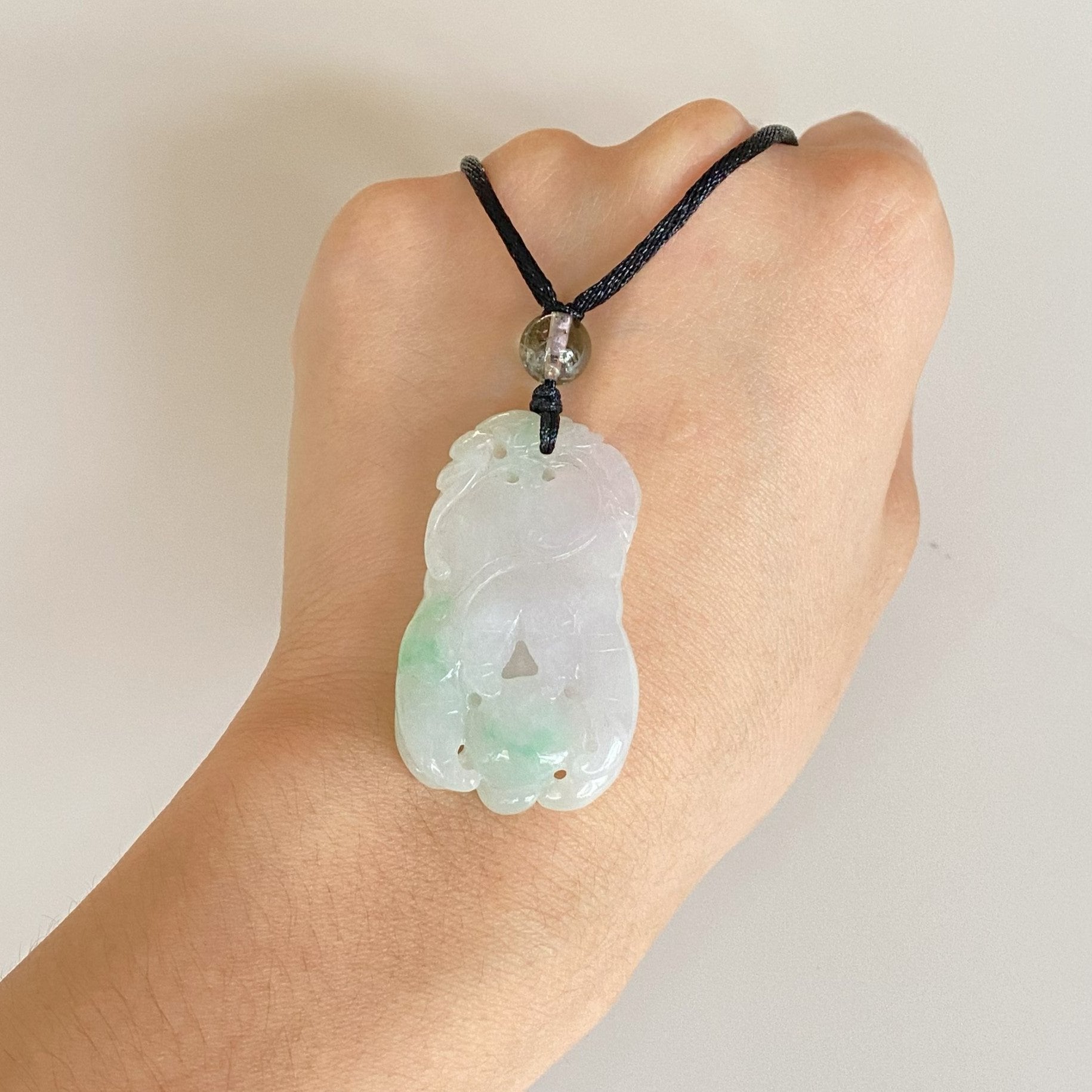 Purple and Green Jade Buddha Hand Pendant with Mudra Symbolism