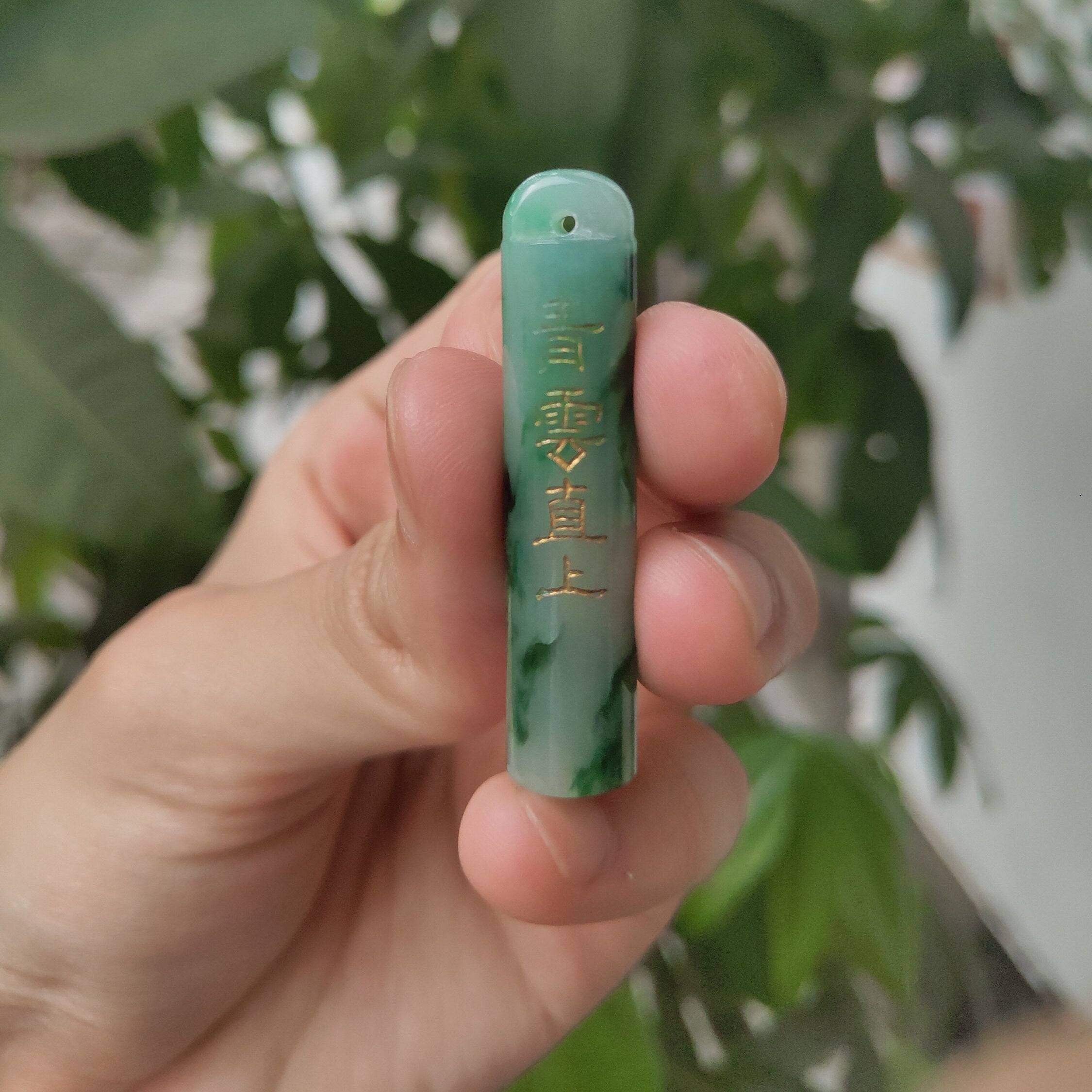 An Exceptional Carved Jadeite Lingguan Tube Pendant Necklace